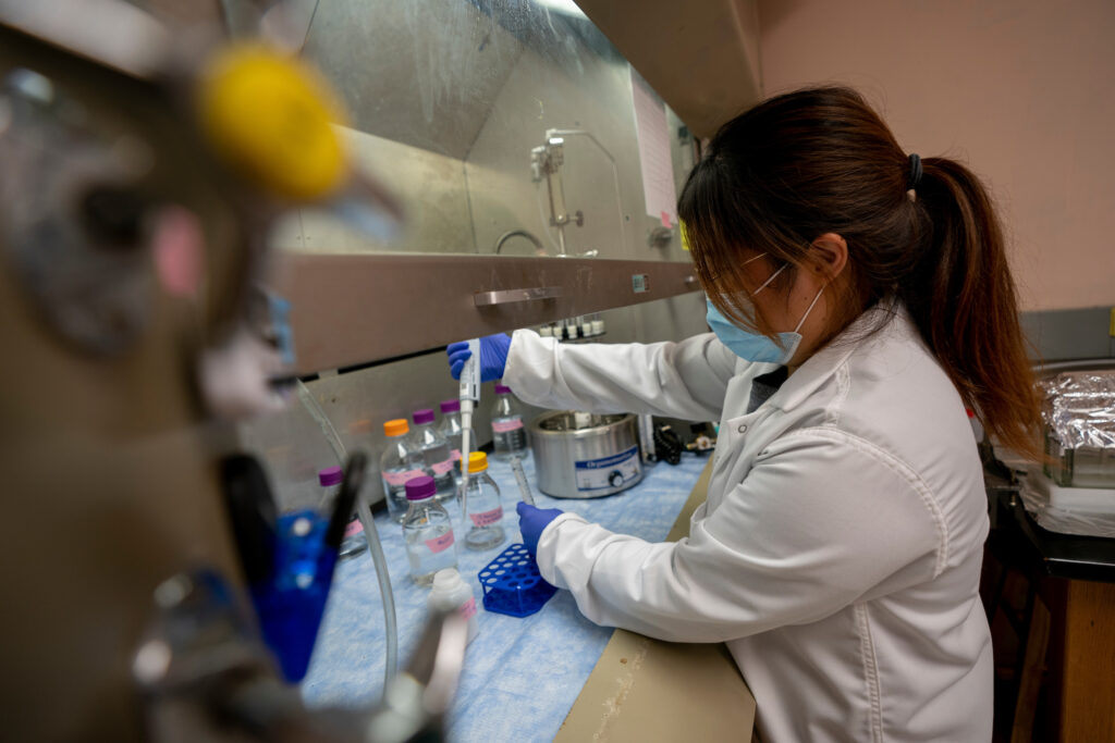 woman wearing a labcoat working in lab