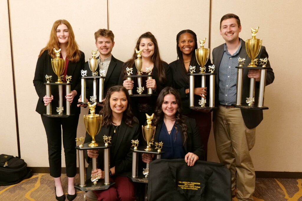 TAMU poultry judging team poses as a group with trophies