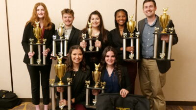 TAMU poultry judging team poses as a group with trophies