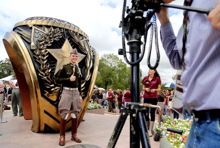 Student standing in front of an Aggie Ring.