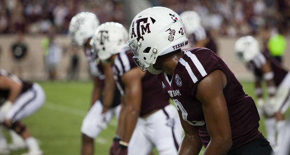 Aggie football players at a game. 