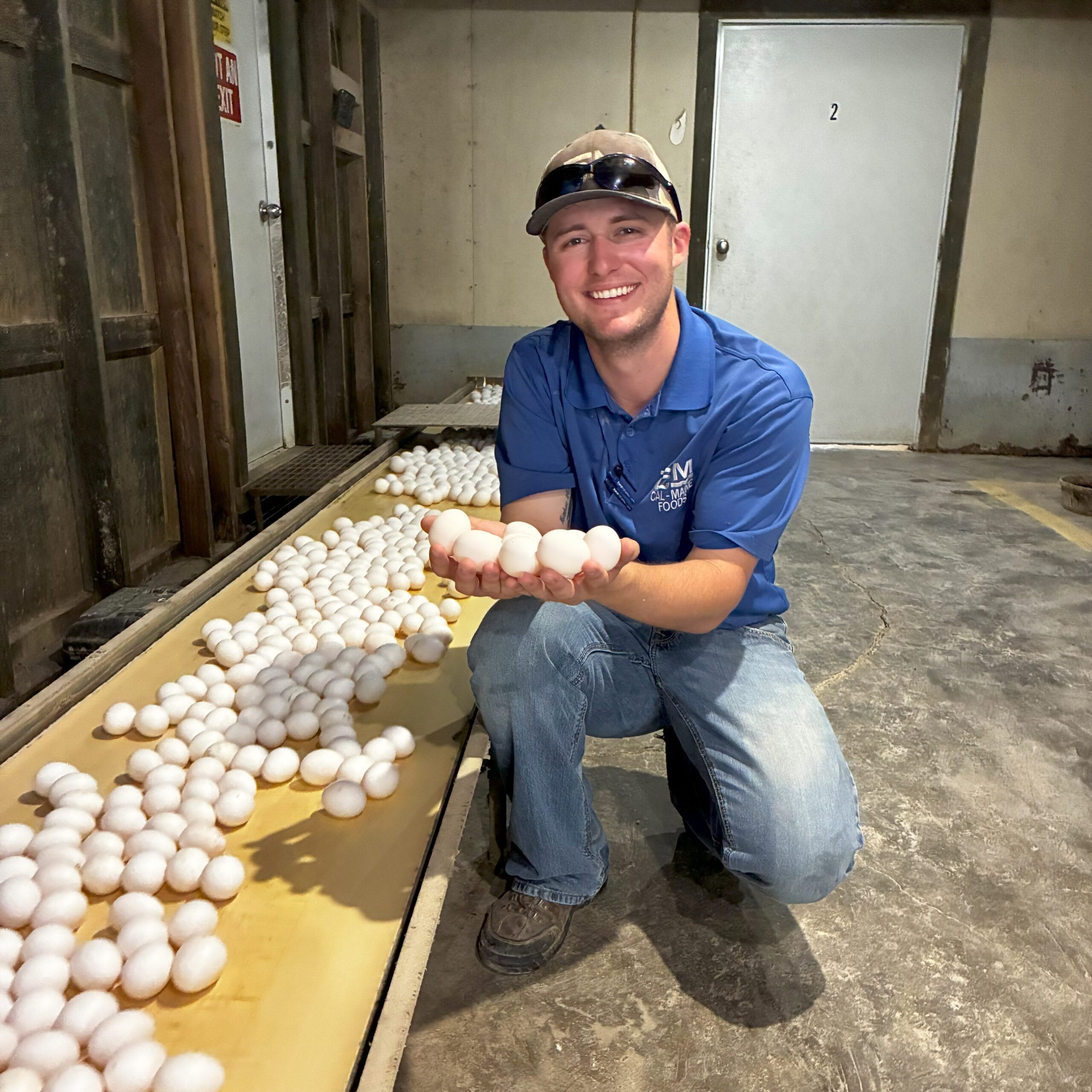 Jackson Lee holding eggs during his internship